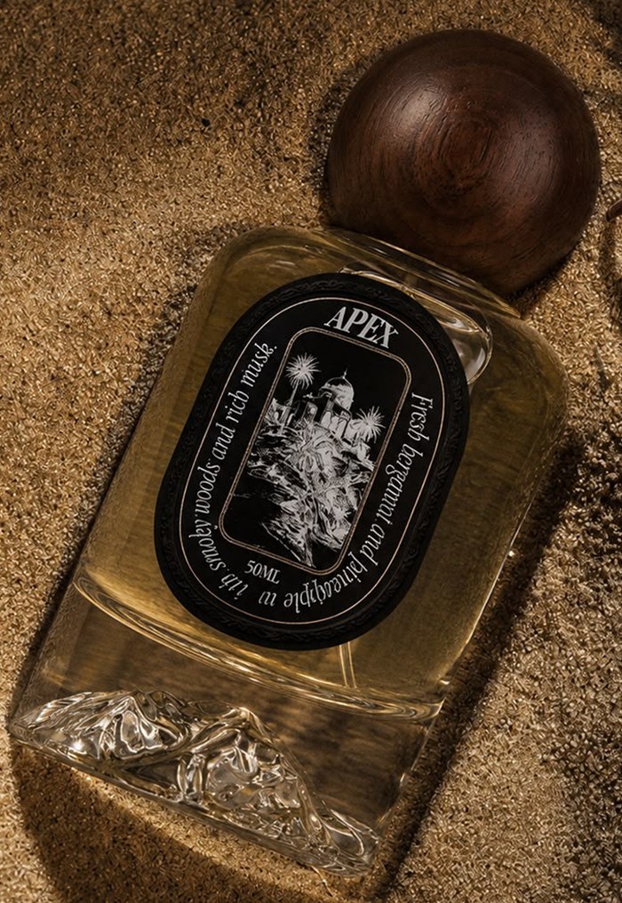 DÖSE Apex eau de parfum bottle on warm golden sand